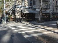 the crosswalk is waiting to cross the street, with several cars driving near by