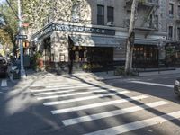 the crosswalk is waiting to cross the street, with several cars driving near by