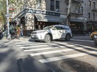 the crosswalk is waiting to cross the street, with several cars driving near by