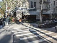 the crosswalk is waiting to cross the street, with several cars driving near by