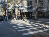 the crosswalk is waiting to cross the street, with several cars driving near by