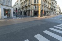 a cross walk on a street corner with buildings and buildings around it in paris, france