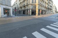 a cross walk on a street corner with buildings and buildings around it in paris, france