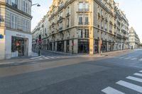 a cross walk on a street corner with buildings and buildings around it in paris, france