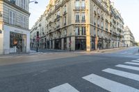 a cross walk on a street corner with buildings and buildings around it in paris, france