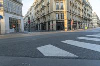 a cross walk on a street corner with buildings and buildings around it in paris, france