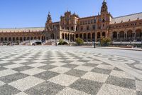 a crowd is walking around in the courtyard of an ornate building with circular patterns on stone flooring