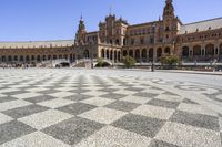 a crowd is walking around in the courtyard of an ornate building with circular patterns on stone flooring