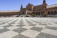 a crowd is walking around in the courtyard of an ornate building with circular patterns on stone flooring