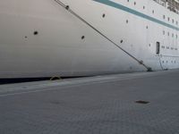 a cruise ship with an engine out side it's doors open and some rope