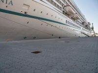 a cruise ship docked in a harbor on a sunny day with no people outside its