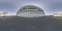 a close up view of a cruise ship parked next to another boat in a marina