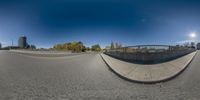 the fisheye lens of a wide angle of a curve road with an asphalt street below