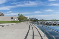 a curved building with a glass front next to another building in a city park area