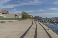 a curved building with a glass front next to another building in a city park area