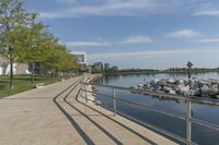 a curved building with a glass front next to another building in a city park area