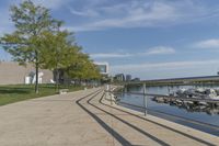 a curved building with a glass front next to another building in a city park area