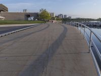 a curved building with a glass front next to another building in a city park area