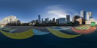 a fisheye lens view of the city with a curved painted parking area and a fountain