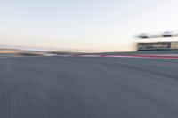 Curved Race Track at Dawn: Racing Under the Clouds