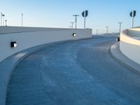 a curved ramp with a clock at the bottom of it to make it easy for people to board