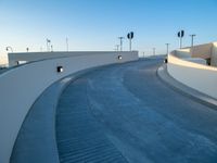 a curved ramp with a clock at the bottom of it to make it easy for people to board