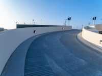 a curved ramp with a clock at the bottom of it to make it easy for people to board