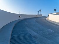 a curved ramp with a clock at the bottom of it to make it easy for people to board