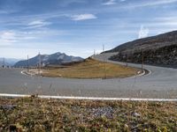 the curved road is winding up to the mountainside at the top of the hill