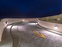 a view of a road and an overpass with traffic passing through it by buildings