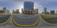 a curved road that has buildings in the back ground and a street leading to it