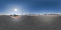 this is a panorama view of a track from the side with a circular shaped field and sun