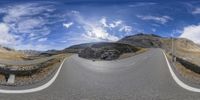 a panoramic view of a curved road going through a mountainous area in switzerland