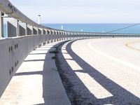 some kind of curved street near the water and sand in the distance is a body of water