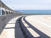 some kind of curved street near the water and sand in the distance is a body of water