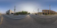 a street is curved in two directions by the power lines in a city setting from the street level looking down