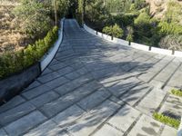 the exterior and landscape of a modern house in los angeles, california with stone and wood