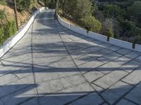 the exterior and landscape of a modern house in los angeles, california with stone and wood