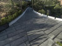 the exterior and landscape of a modern house in los angeles, california with stone and wood