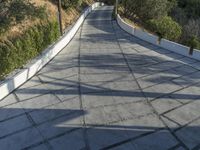 the exterior and landscape of a modern house in los angeles, california with stone and wood