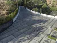 the exterior and landscape of a modern house in los angeles, california with stone and wood