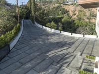 the exterior and landscape of a modern house in los angeles, california with stone and wood