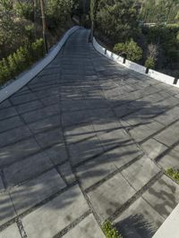 the exterior and landscape of a modern house in los angeles, california with stone and wood