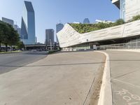 a curved walkway on the side of an empty street in a city area with tall buildings