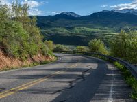 Curving Road in Colorado Landscape with Majestic Mountain View