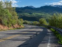 Curving Road in Colorado Landscape with Majestic Mountain View