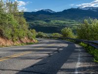 Curving Road in Colorado Landscape with Majestic Mountain View