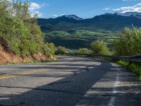 Curving Road in Colorado Landscape with Majestic Mountain View