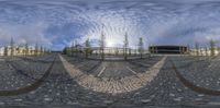 a person standing in the middle of a circle with multiple curves on it, against a cloudy sky