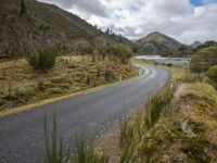 Curvy Asphalt Road Through Highlands with Mountain Views